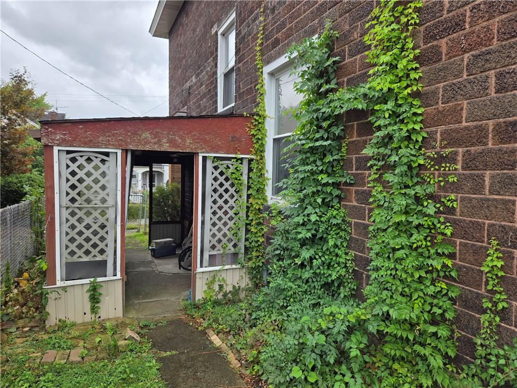 438 8th Street Donora, PA 15033 - Photo 22 of 26 a view of a brick house with plants and large tree