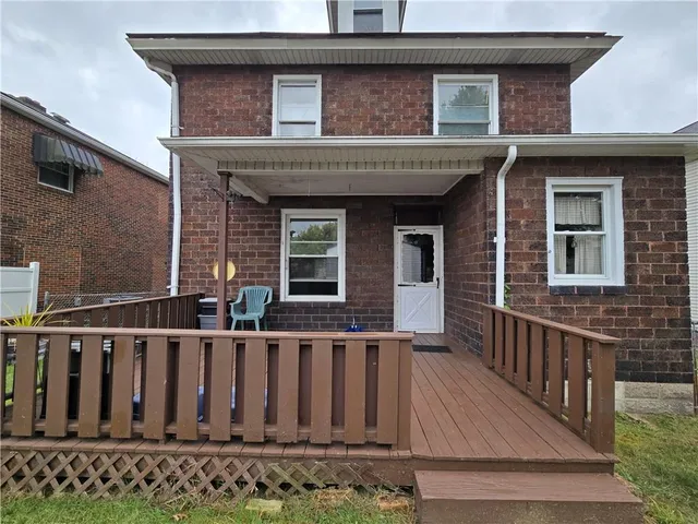 a view of a house with wooden fence