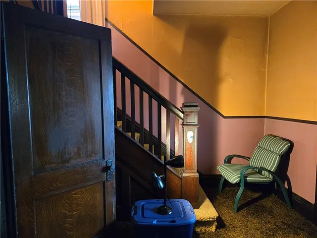 a view of a balcony with chairs and a potted plant
