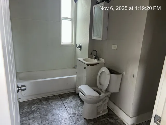 a bathroom with a toilet a sink and bathtub