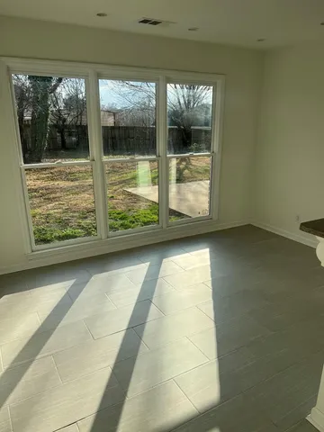 a view of a glass door with a yard