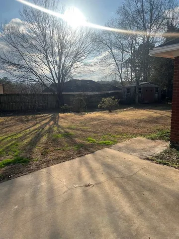 a view of empty room with wooden fence