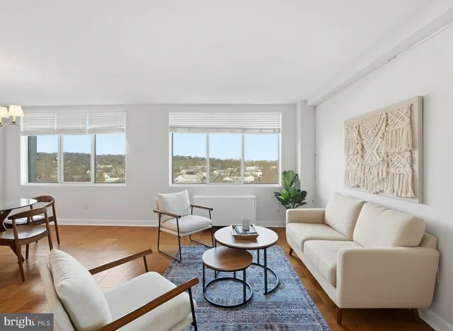 a living room with furniture and a window with wooden floor