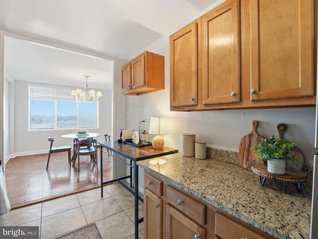 a kitchen with stainless steel appliances granite countertop a sink a stove and cabinets
