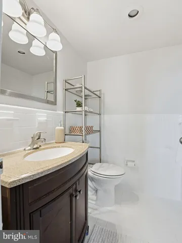a bathroom with a sink a toilet and vanity