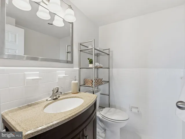 a bathroom with a sink a toilet and a mirror