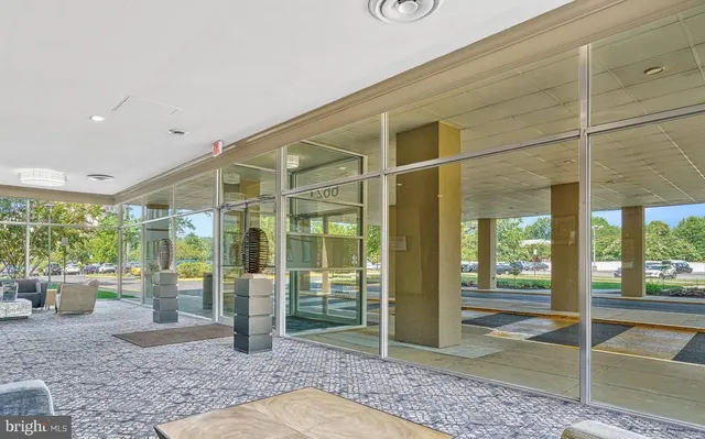 a view of a porch with a table and chairs