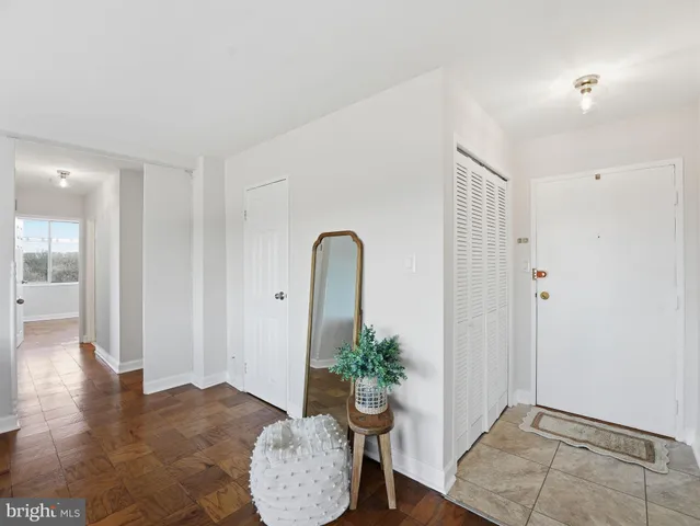 a living room with furniture and potted plant