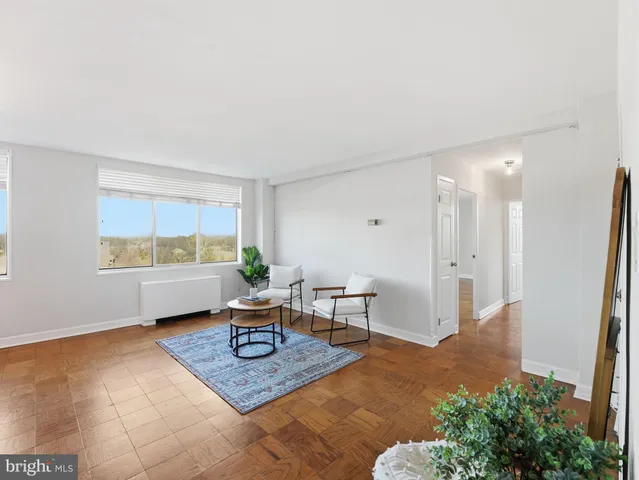 a living room with furniture a window and a table