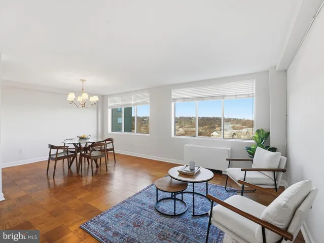 a living room with furniture a dining table and a window
