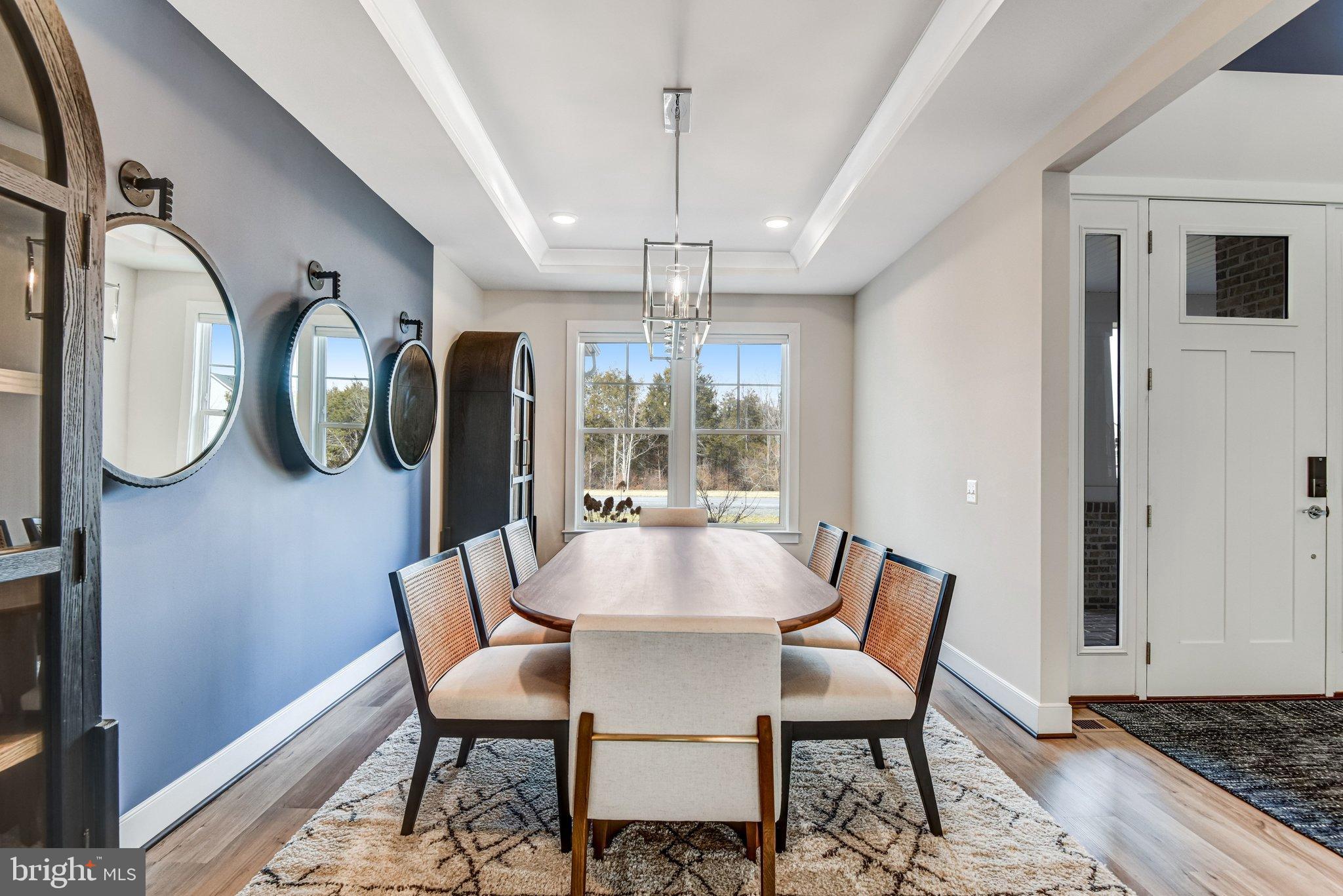 43199 Dogan Rdg Place Centreville, VA 20120 - Photo 20 of 86 a view of a dining room with furniture a chandelier and wooden floor