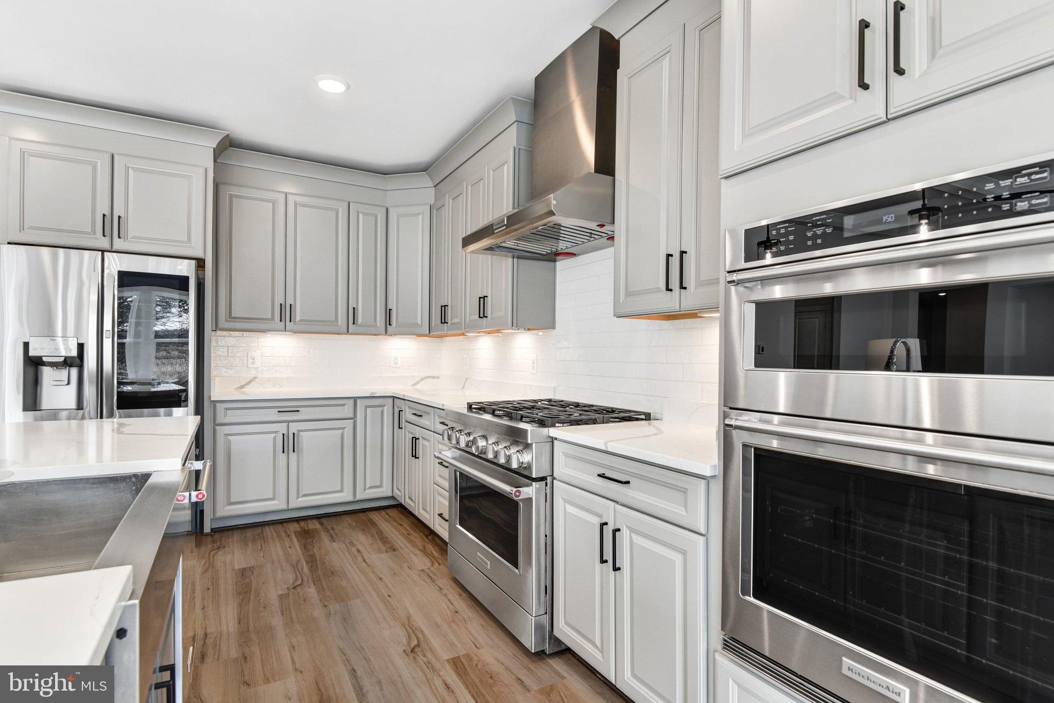 43199 Dogan Rdg Place Centreville, VA 20120 - Photo 25 of 86 a kitchen with stainless steel appliances white cabinets and white appliances