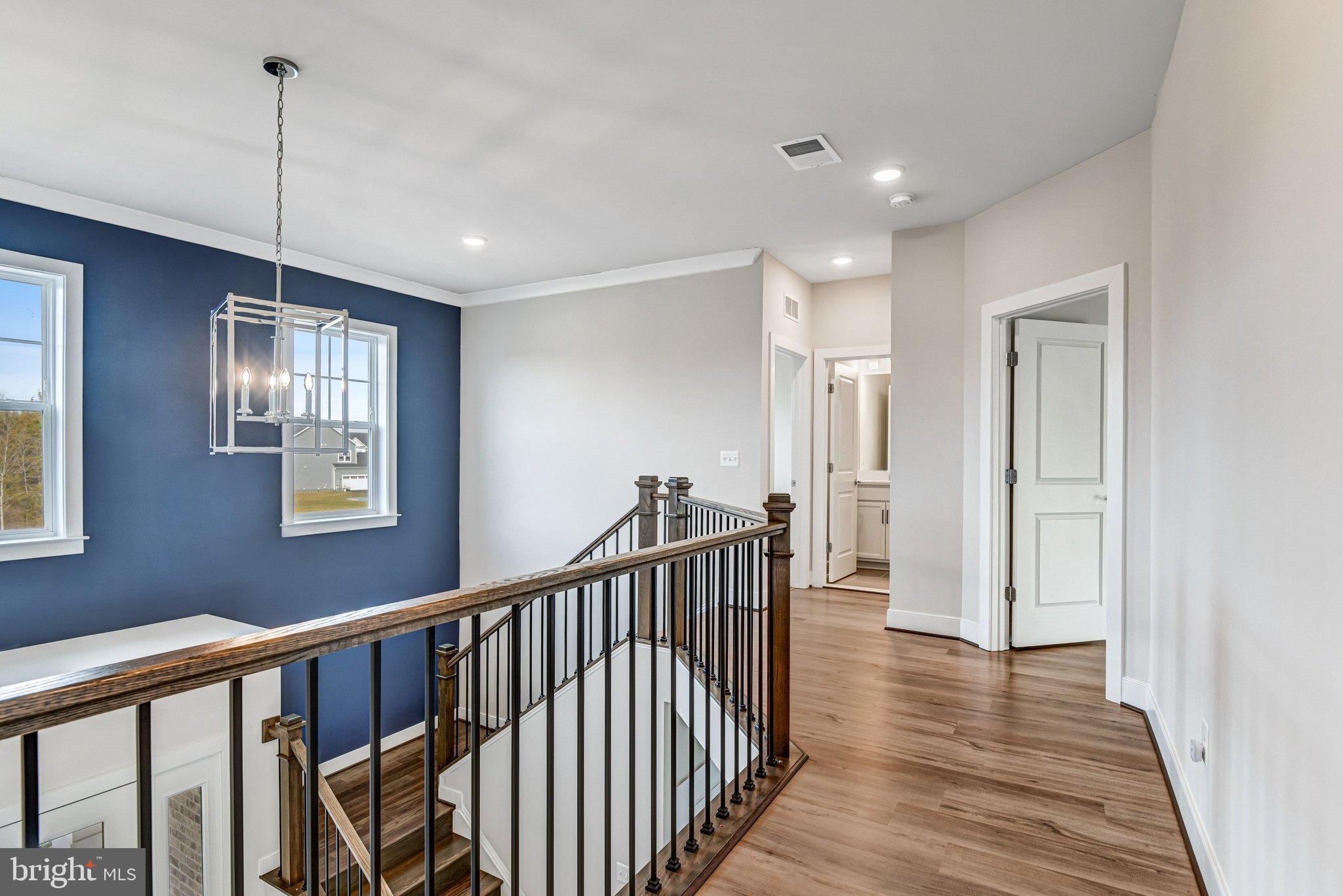 43199 Dogan Rdg Place Centreville, VA 20120 - Photo 31 of 86 a view of a hallway with wooden floor and windows