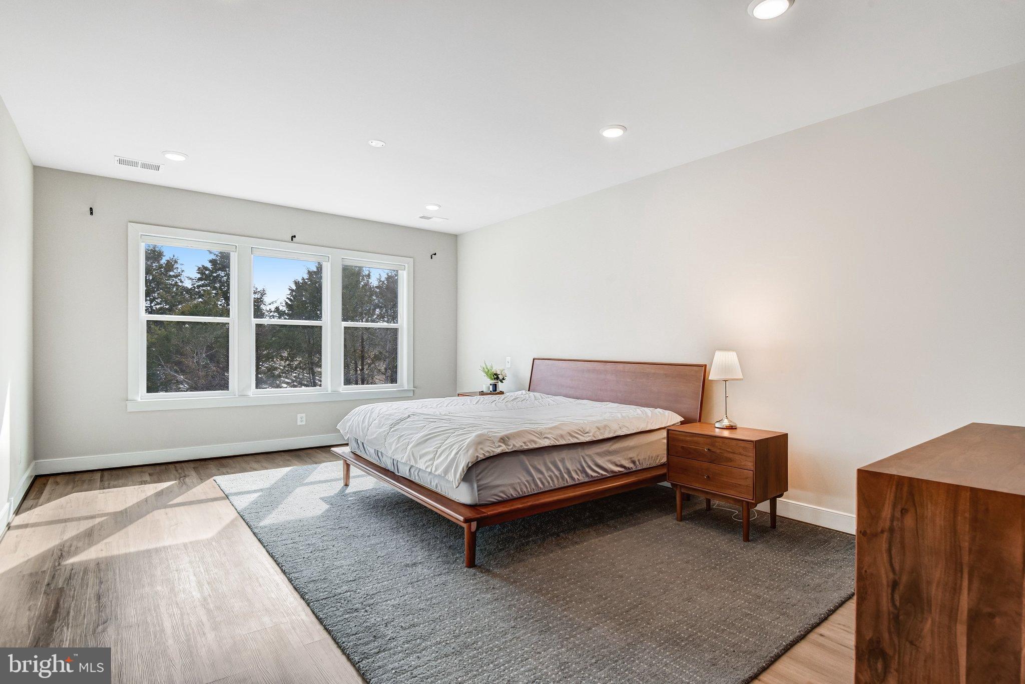 43199 Dogan Rdg Place Centreville, VA 20120 - Photo 36 of 86 a bedroom with a bed lamp and a large window
