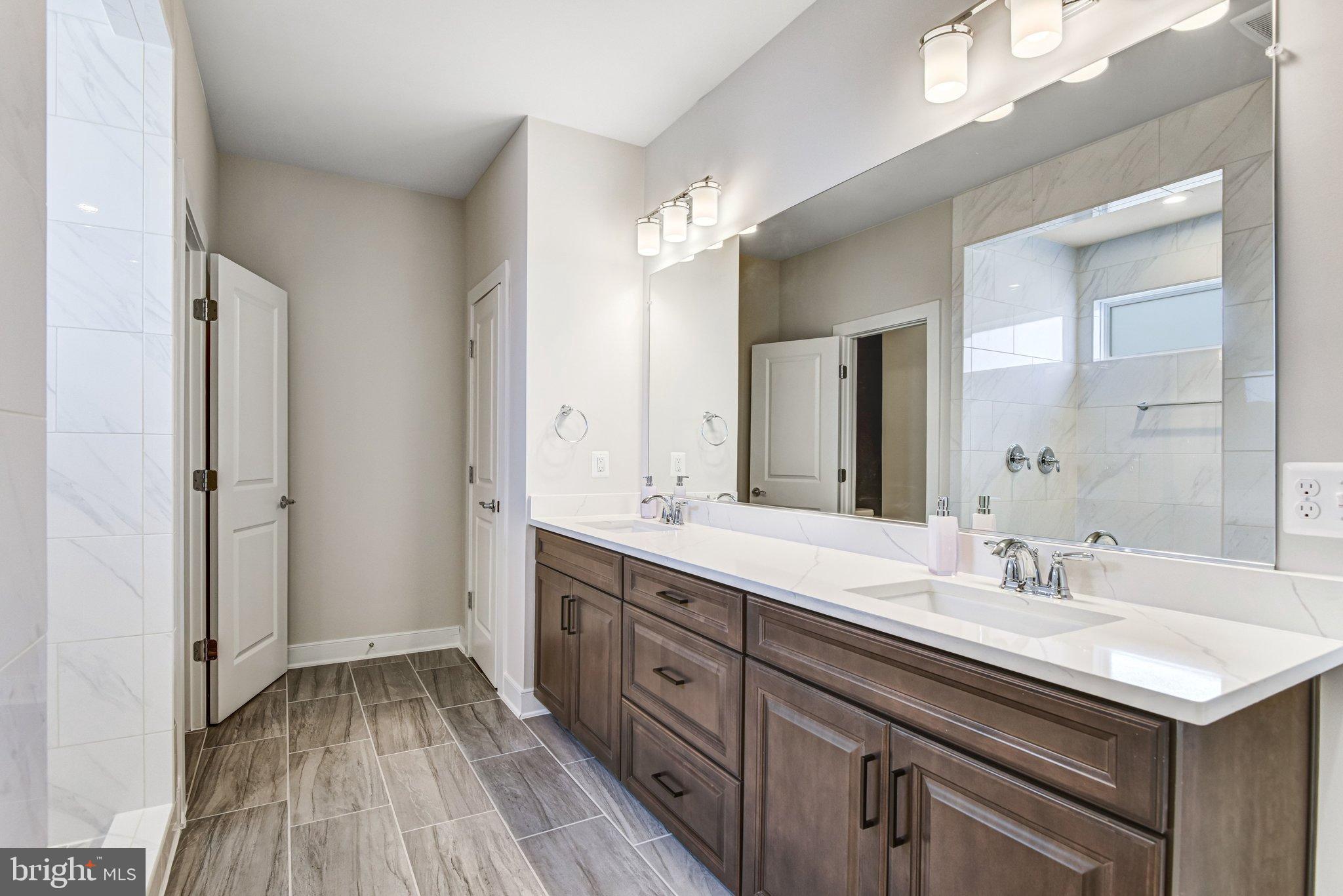 43199 Dogan Rdg Place Centreville, VA 20120 - Photo 40 of 86 a bathroom with a sink and a mirror