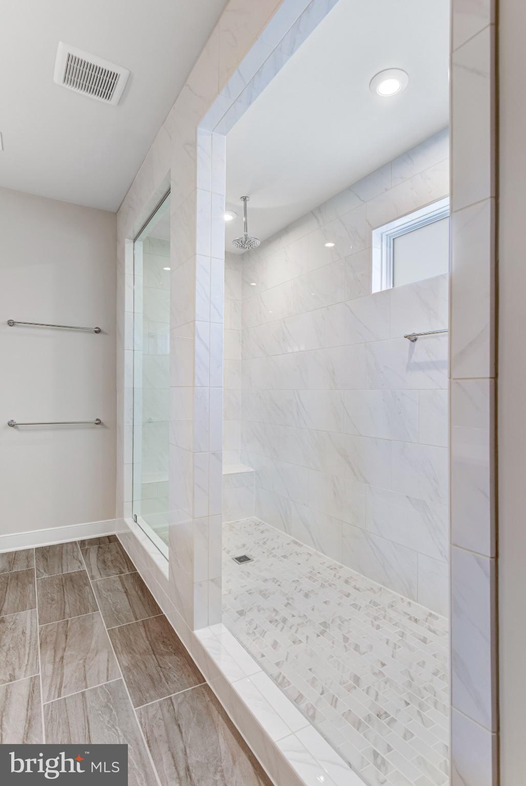 43199 Dogan Rdg Place Centreville, VA 20120 - Photo 42 of 86 Sleek modern shower with elegant tile design.