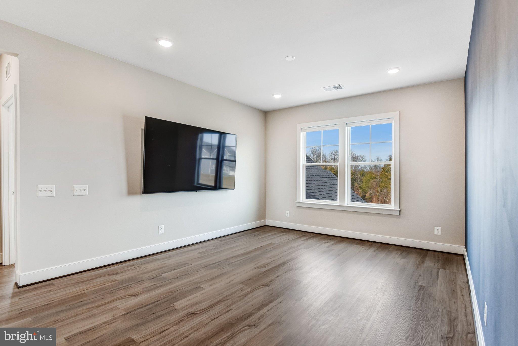 43199 Dogan Rdg Place Centreville, VA 20120 - Photo 43 of 86 a view of an empty room with wooden floor and a window