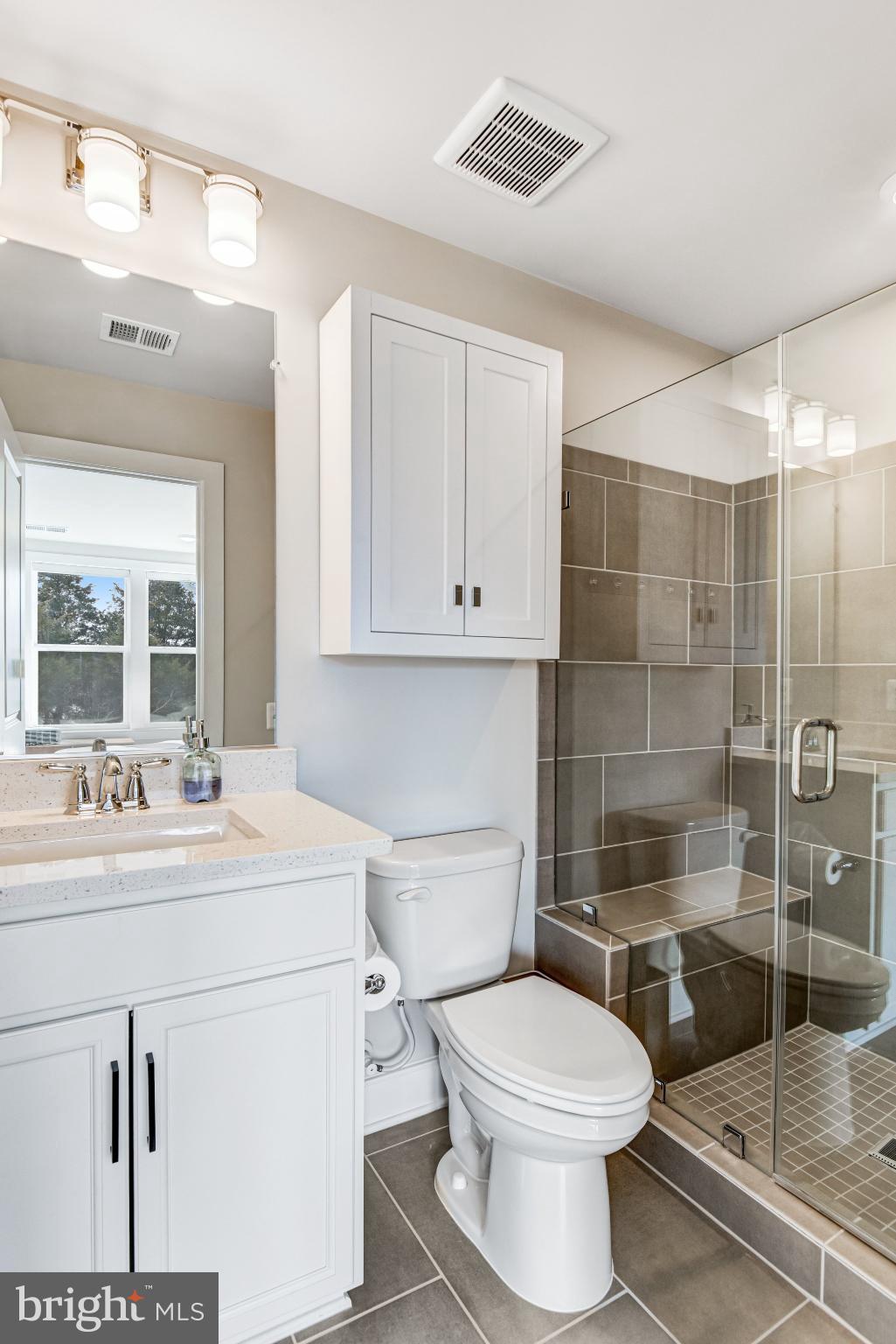 43199 Dogan Rdg Place Centreville, VA 20120 - Photo 48 of 86 a bathroom with a toilet sink vanity and mirror