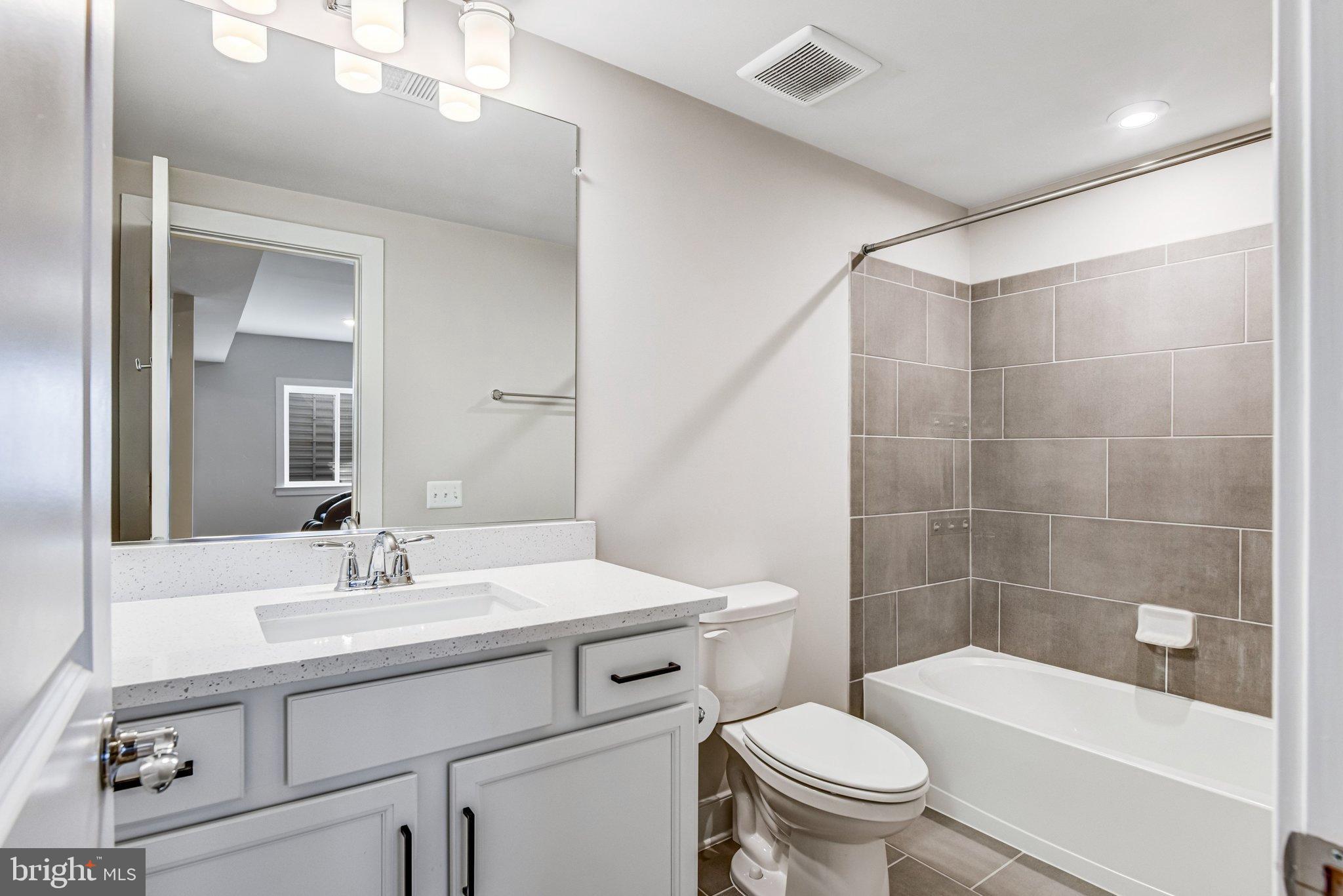 43199 Dogan Rdg Place Centreville, VA 20120 - Photo 62 of 86 a bathroom with a sink a toilet and shower