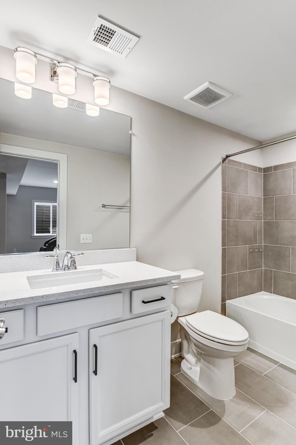 43199 Dogan Rdg Place Centreville, VA 20120 - Photo 63 of 86 a bathroom with a sink a toilet and shower