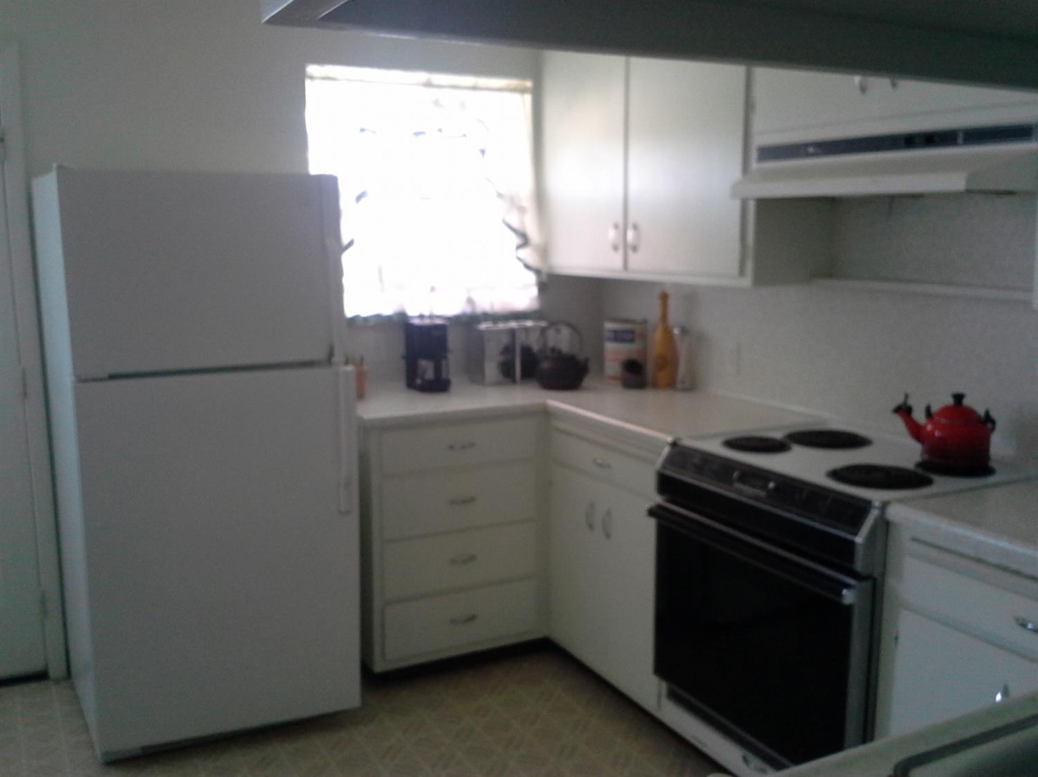29939 Highway 4 Farmington, CA 95230 - Photo 20 of 25 a kitchen with a refrigerator sink and cabinets