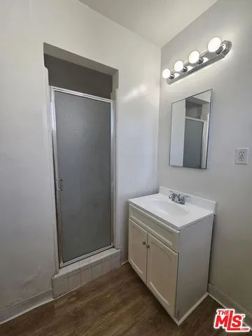 a bathroom with a sink a light fixture and a mirror