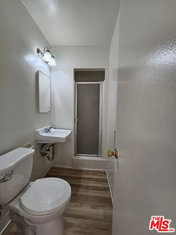 a bathroom with a sink a toilet a mirror and vanity