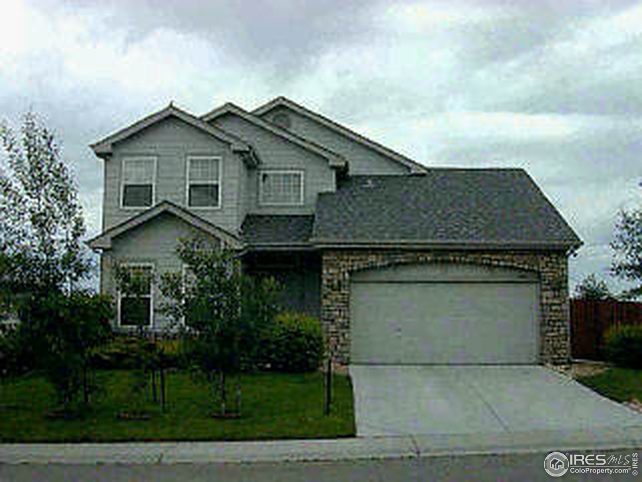 594 Rider Ridge Drive Longmont, CO 80504 - Photo 1 of 2 a front view of a house with a garden