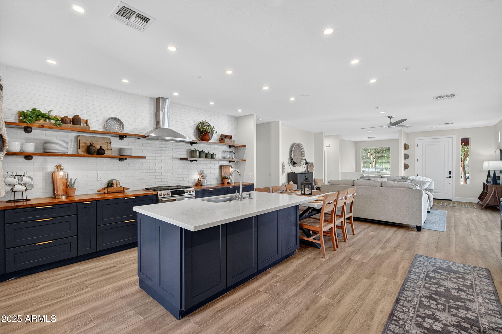 3059 East Agritopia Loop North Gilbert, AZ 85296 - Photo 12 of 85 a kitchen with stainless steel appliances granite countertop wooden cabinets and sink
