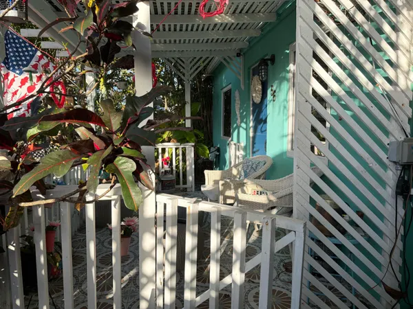 a dining room with furniture and a potted plant