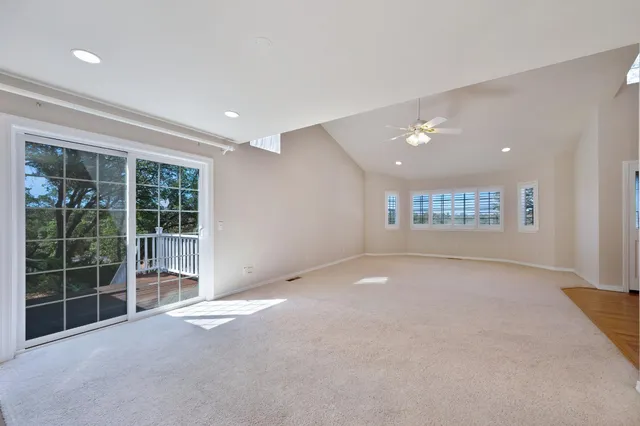 a kitchen with stainless steel appliances granite countertop a stove a sink a refrigerator and chairs