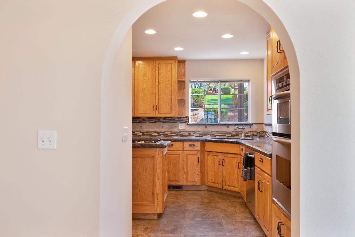 3730 Kimo Way Auburn, CA 95602 - Photo 18 of 75 a kitchen with stainless steel appliances granite countertop a stove and a sink