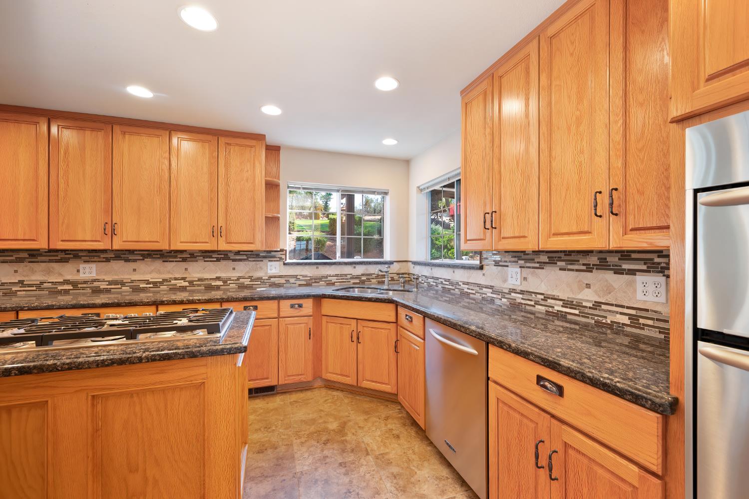 3730 Kimo Way Auburn, CA 95602 - Photo 19 of 75 a kitchen with stainless steel appliances granite countertop a sink stove and cabinets