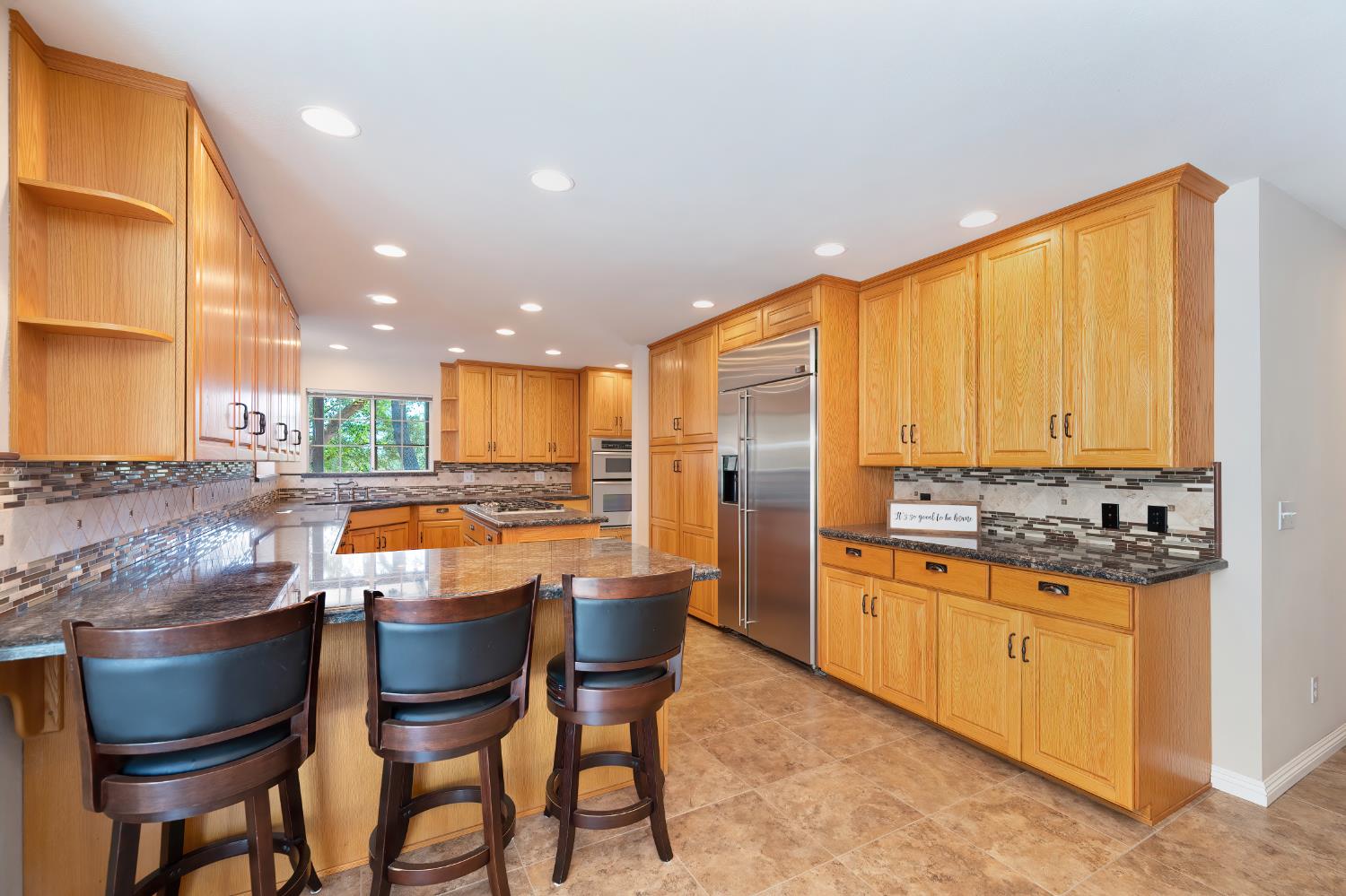 3730 Kimo Way Auburn, CA 95602 - Photo 22 of 75 a kitchen with stainless steel appliances granite countertop a stove a sink a refrigerator and chairs