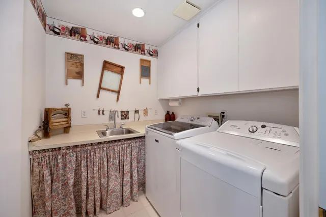 a view of a house with a large tree and a yard