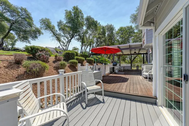 a view of outdoor space with deck and trees