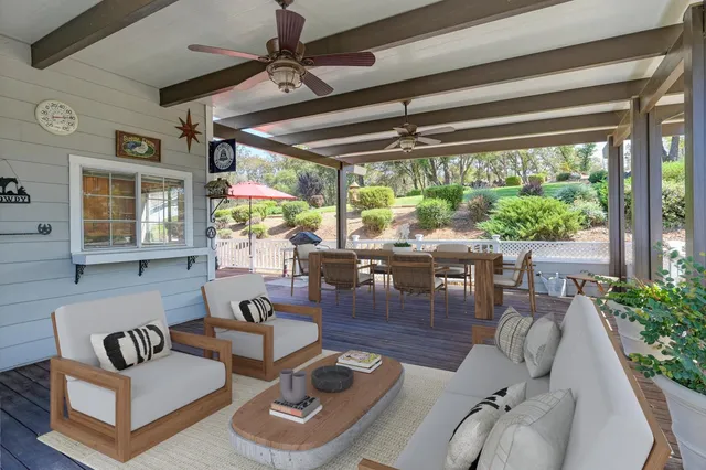 a view of balcony with wooden floor and outdoor seating