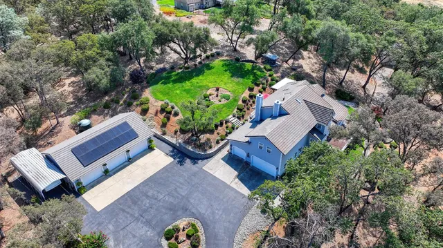 a front view of a house with a yard and potted plants