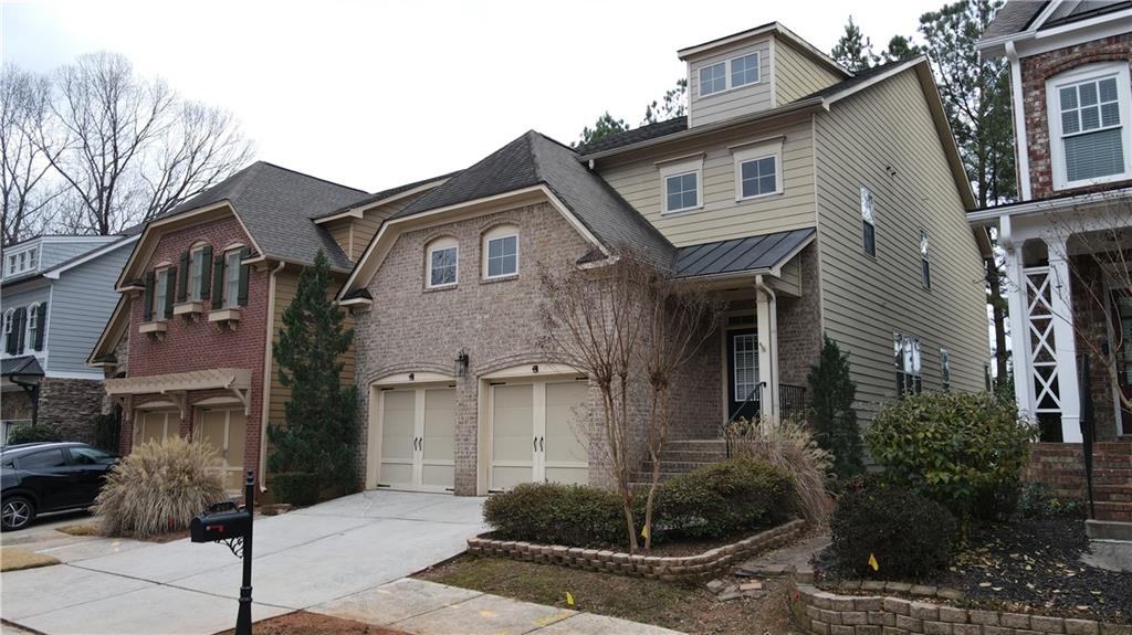 548 Myrtle Trace Lane Suwanee, GA 30024 - Photo 13 of 74 a front view of a house with garden