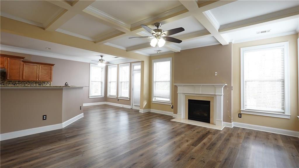 548 Myrtle Trace Lane Suwanee, GA 30024 - Photo 20 of 74 a view of an empty room with window and wooden floor
