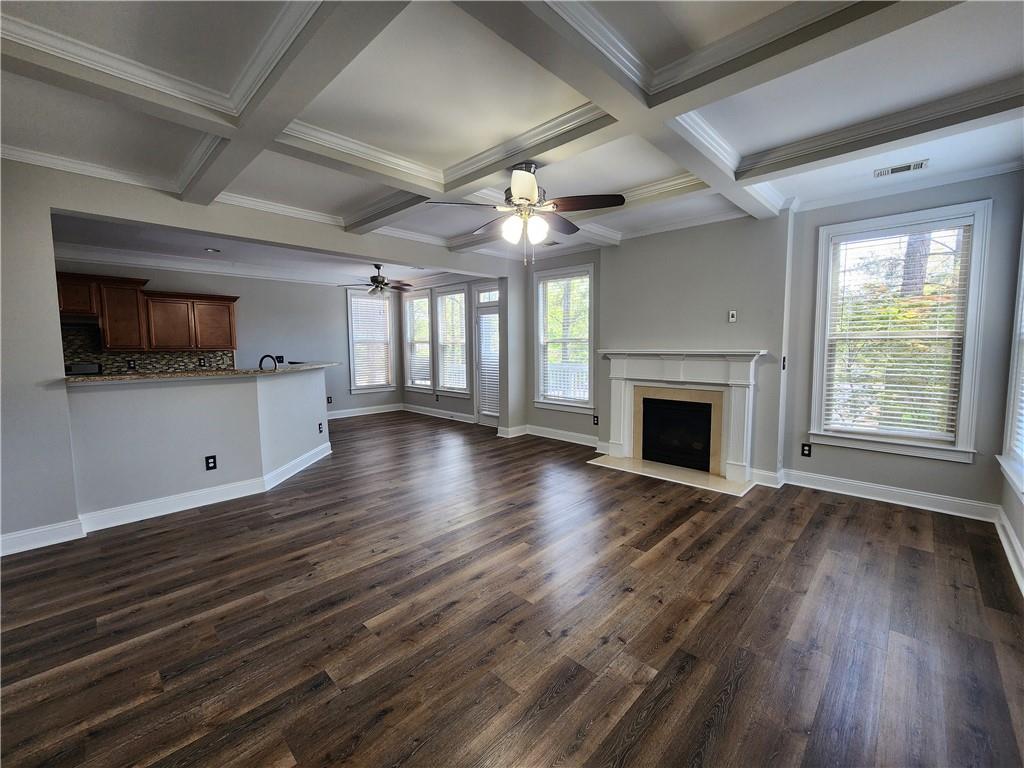 548 Myrtle Trace Lane Suwanee, GA 30024 - Photo 22 of 87 an empty room with wooden floor a fireplace and windows