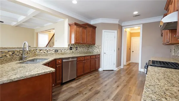 a view of a room with wooden floor and ceiling fan