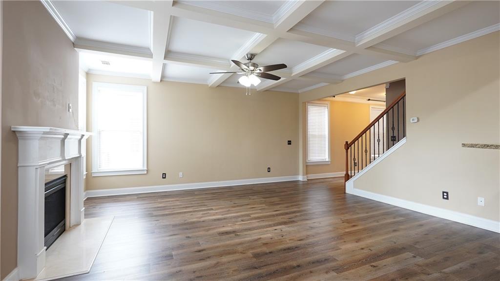 548 Myrtle Trace Lane Suwanee, GA 30024 - Photo 29 of 87 an empty room with wooden floor fan and windows