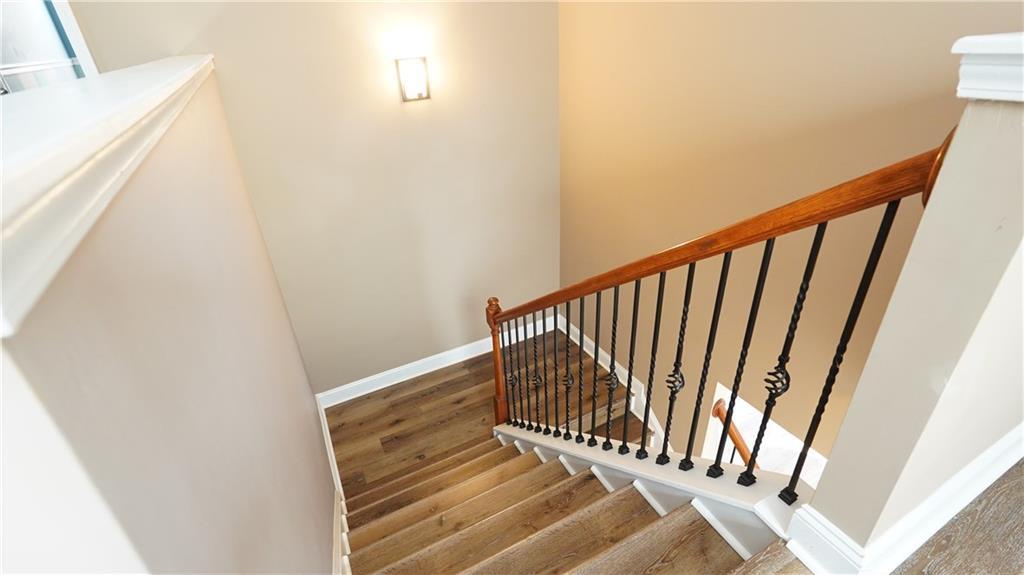 548 Myrtle Trace Lane Suwanee, GA 30024 - Photo 41 of 87 a view of staircase with white walls and a window