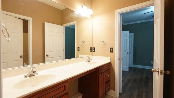 a view of walk in closet with wooden floor