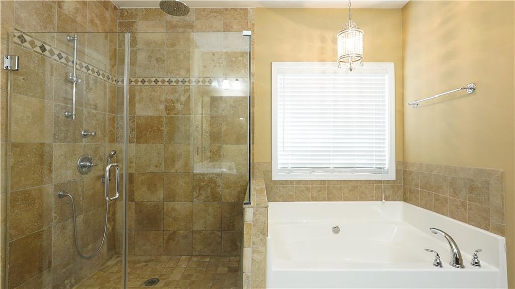 548 Myrtle Trace Lane Suwanee, GA 30024 - Photo 47 of 87 a bathroom with a bathtub and shower