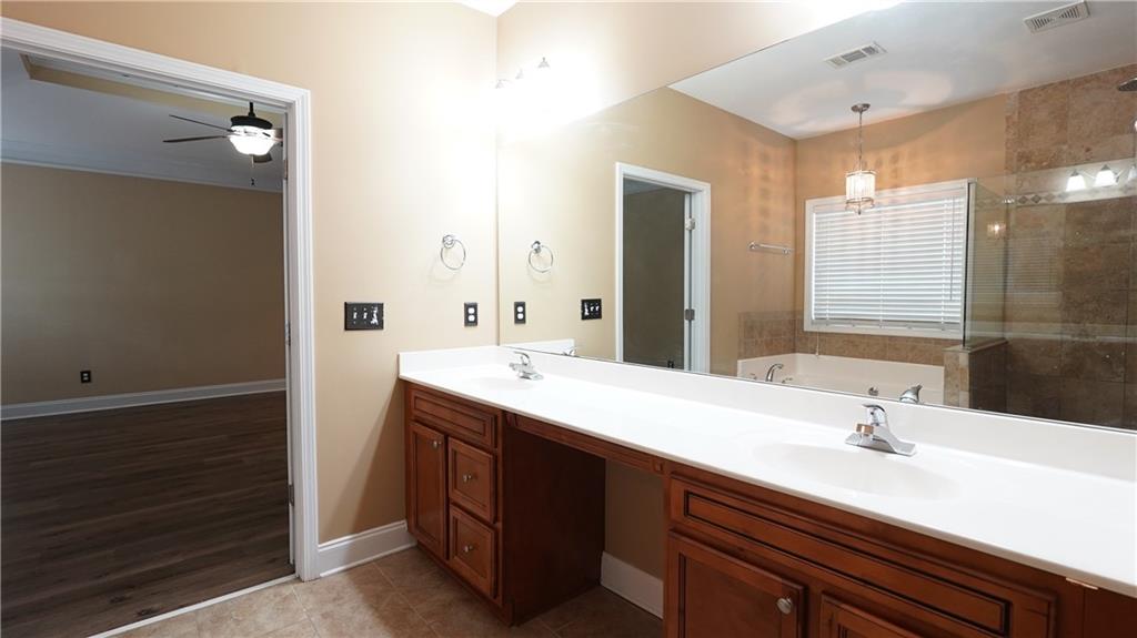 548 Myrtle Trace Lane Suwanee, GA 30024 - Photo 48 of 87 a spacious bathroom with a double vanity sink a mirror and a shower