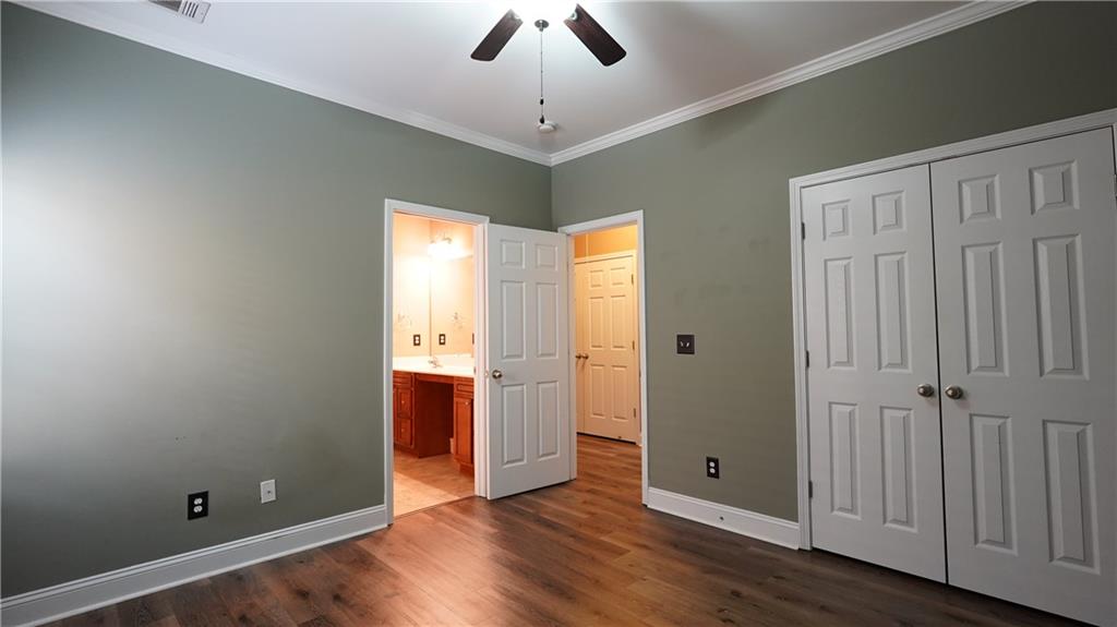 548 Myrtle Trace Lane Suwanee, GA 30024 - Photo 50 of 74 an empty room with wooden floor cabinet and windows