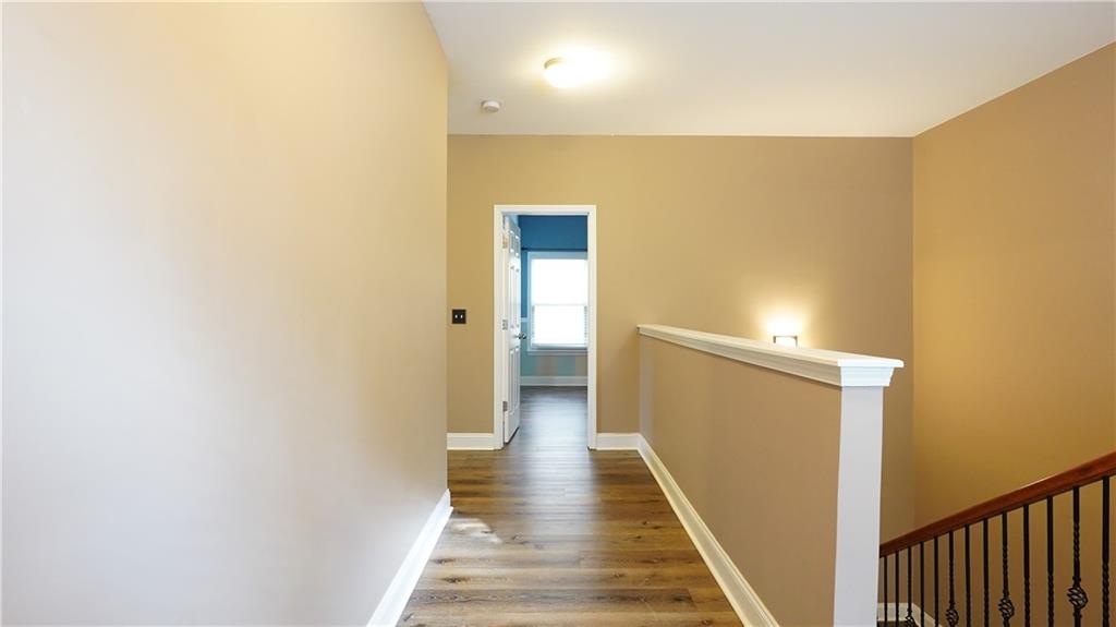 548 Myrtle Trace Lane Suwanee, GA 30024 - Photo 50 of 87 a view of a hallway with wooden floor