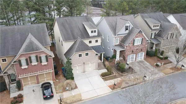 an aerial view of a house with a swimming pool and outdoor space